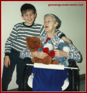 Young Boy Giving his Great Grandmother Cuddly Toys