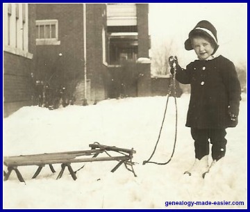 Little girl with sled in snow